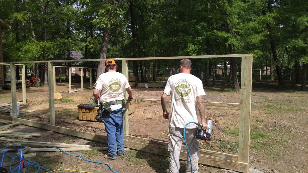 Crew building a wood privacy fence