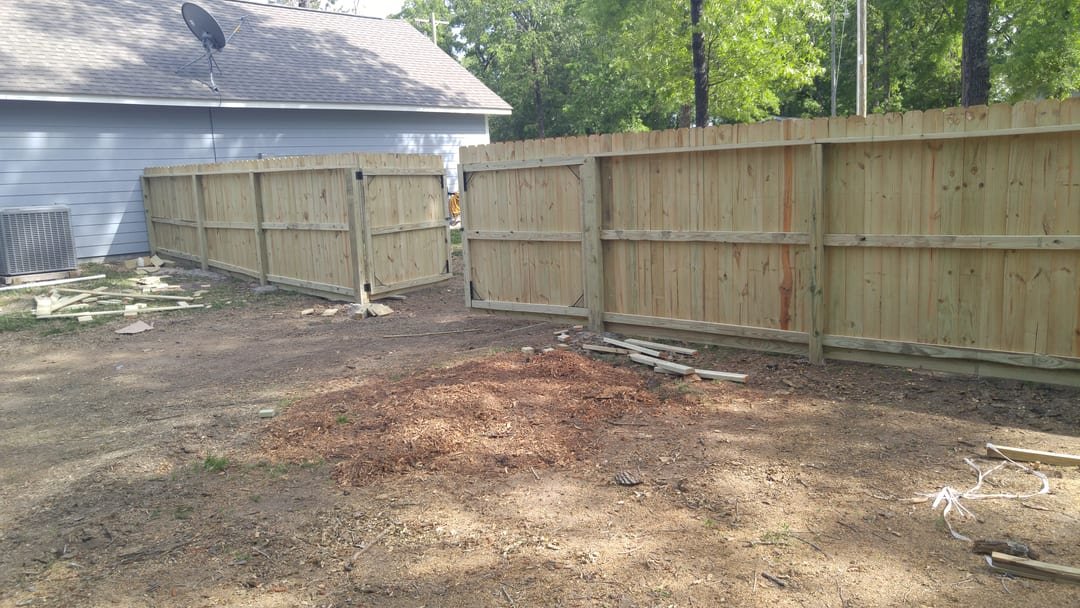 Crew setting posts and rails for a wood fence