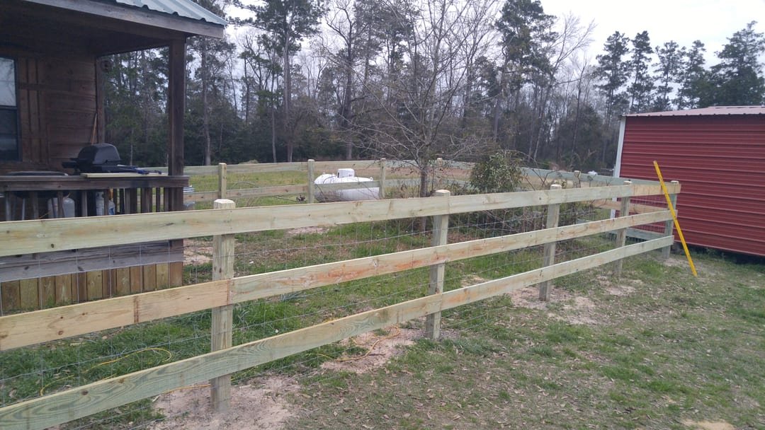 Livestock panel fence near a cabin