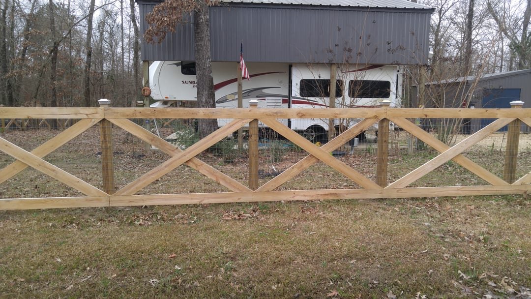 Cross buck wood fence along an RV property