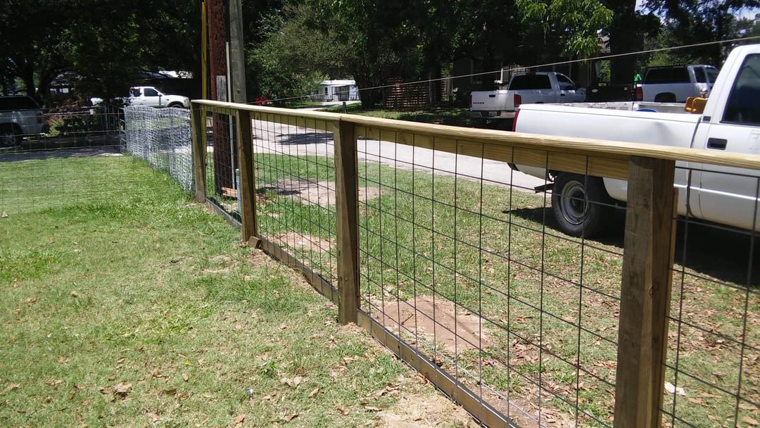 Field fence along a gravel driveway