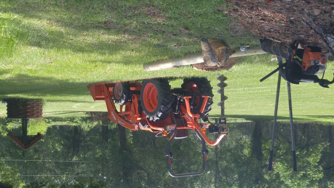 Wood posts being set for a fence line