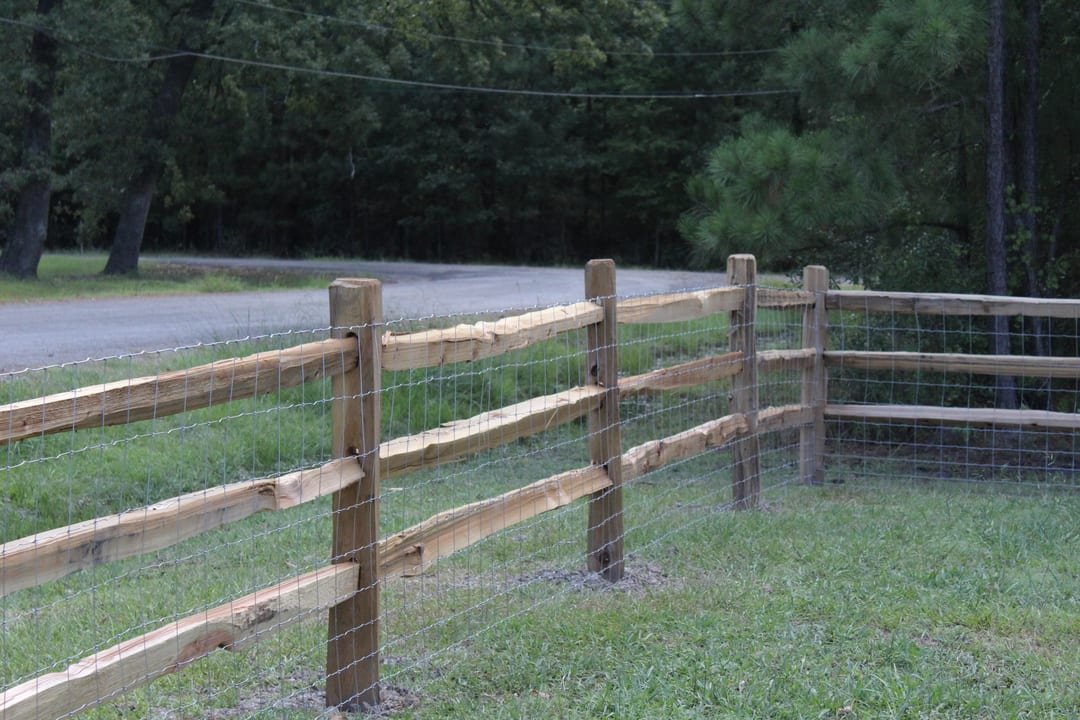 Split rail fence with wire backing along a pasture