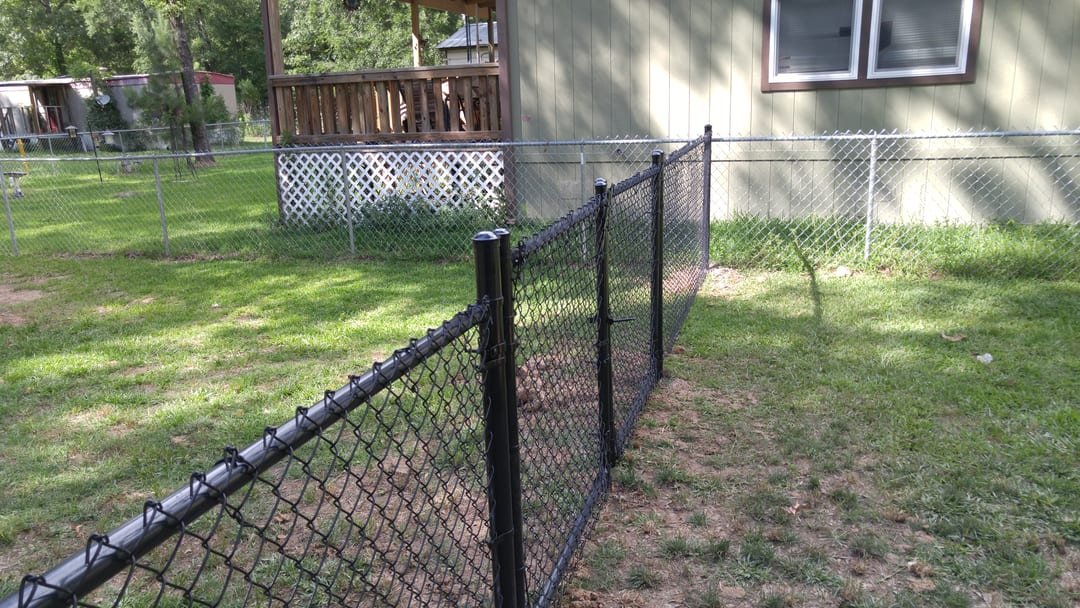 Chain link fence beside a lake house