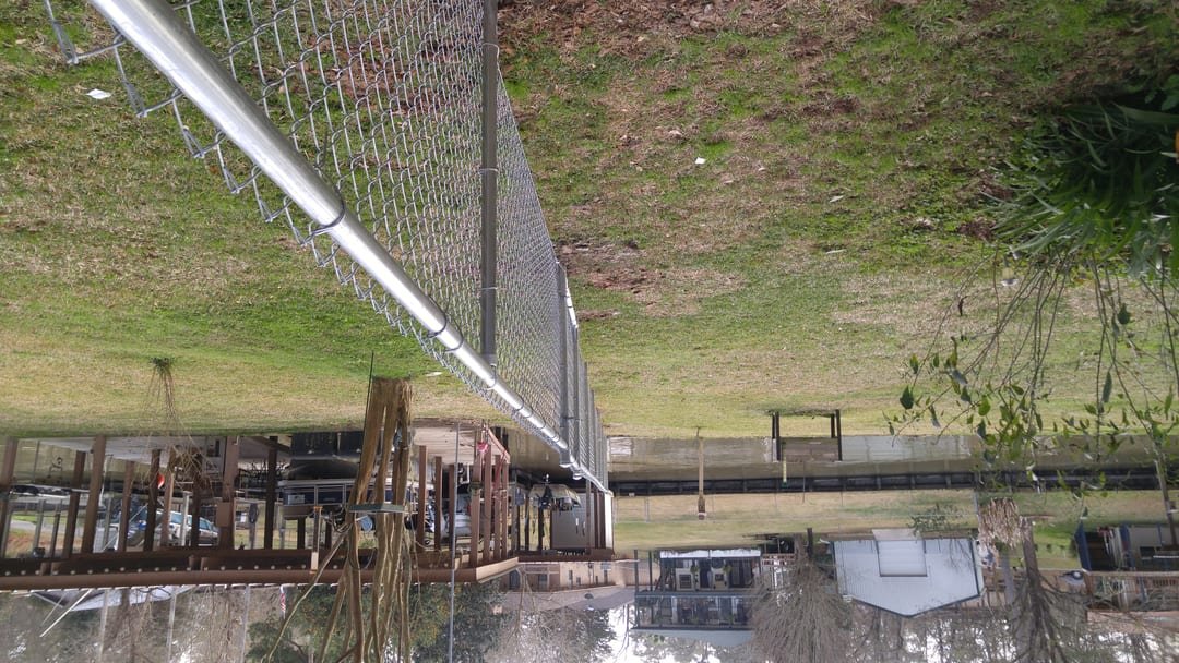 Chain link fence running down to the shoreline on a Lake Livingston lot