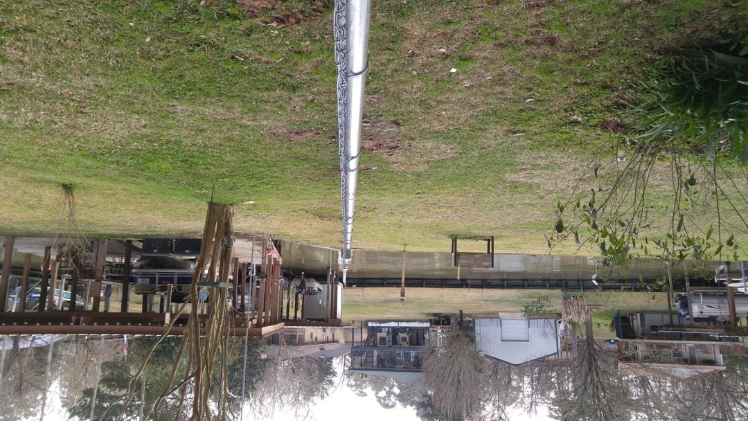 Chain link fence stepping down a sloped Lake Livingston lot