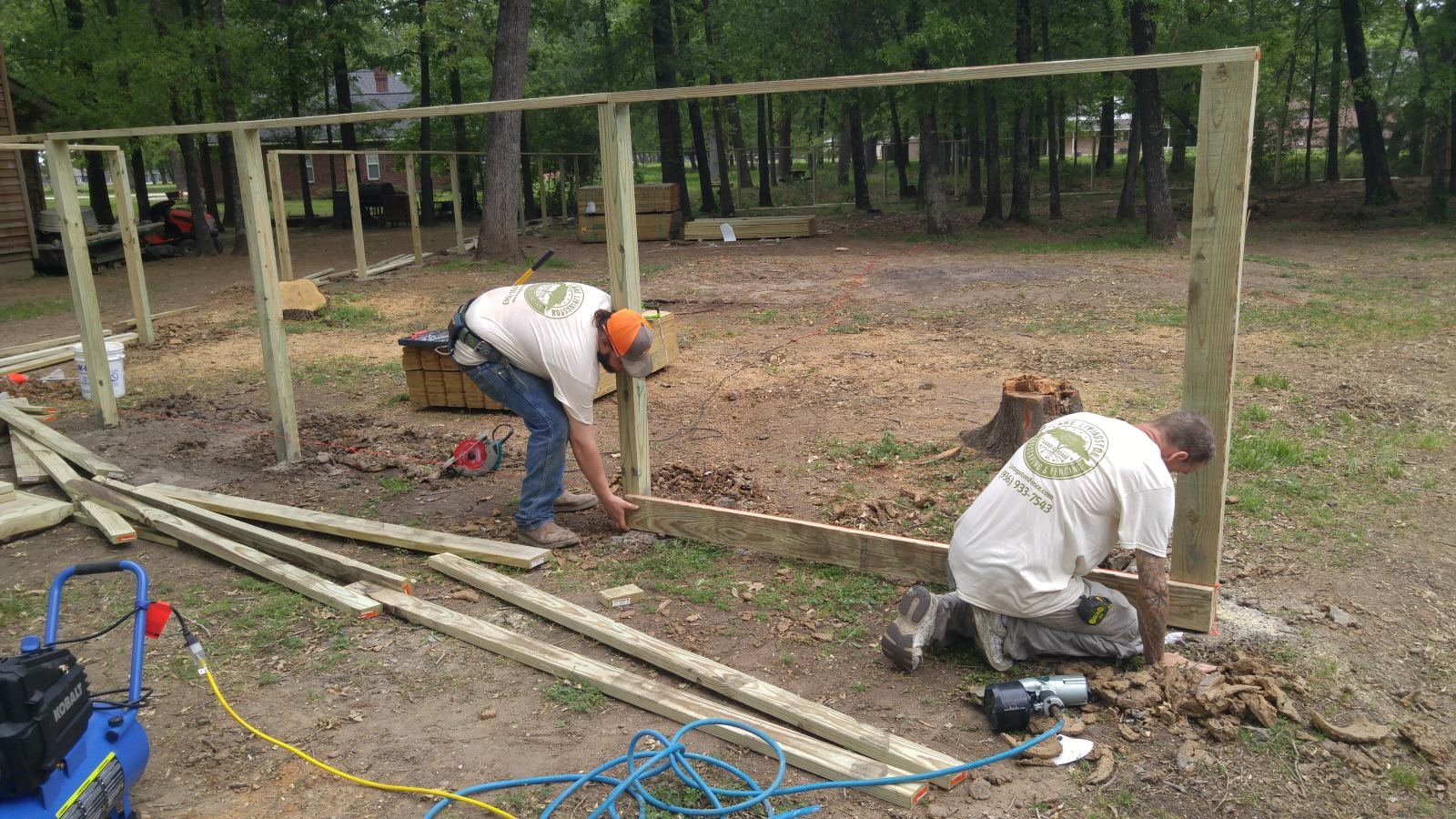 Crew building a wood privacy fence