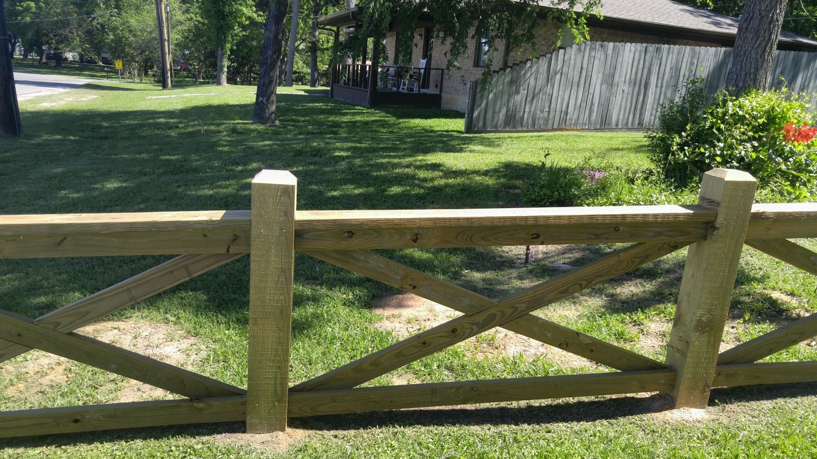 Cross-buck fence along a front yard and driveway