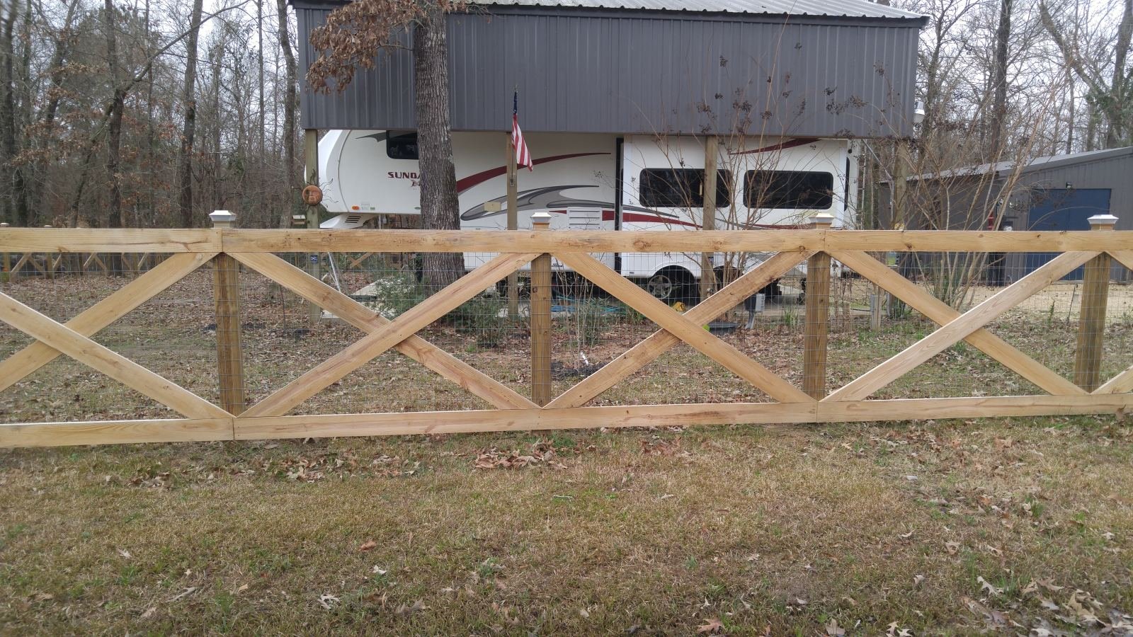 Cross-buck fence enclosing an RV and camper property