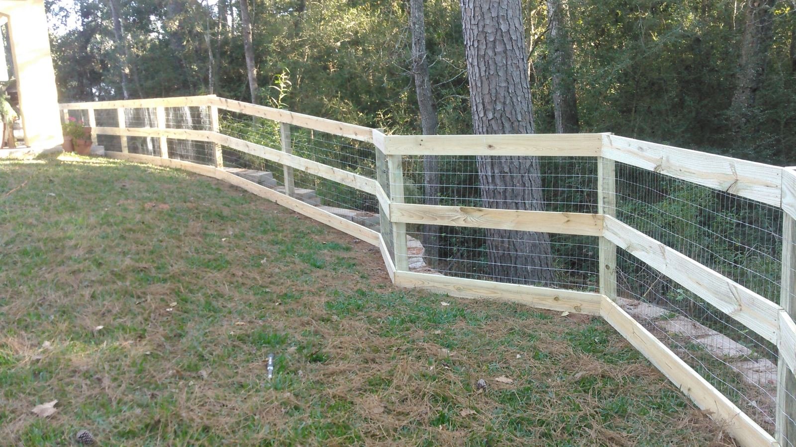 Wood rail and wire corral fence around a residential property