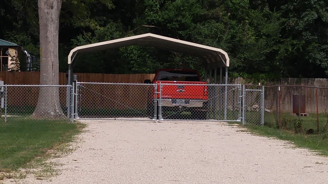 Chain-link driveway gate at a residential property