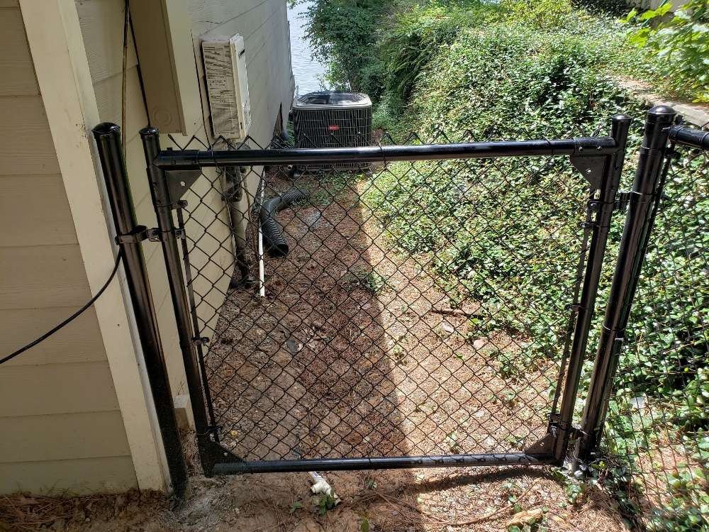 Chain-link gate at a lakefront property