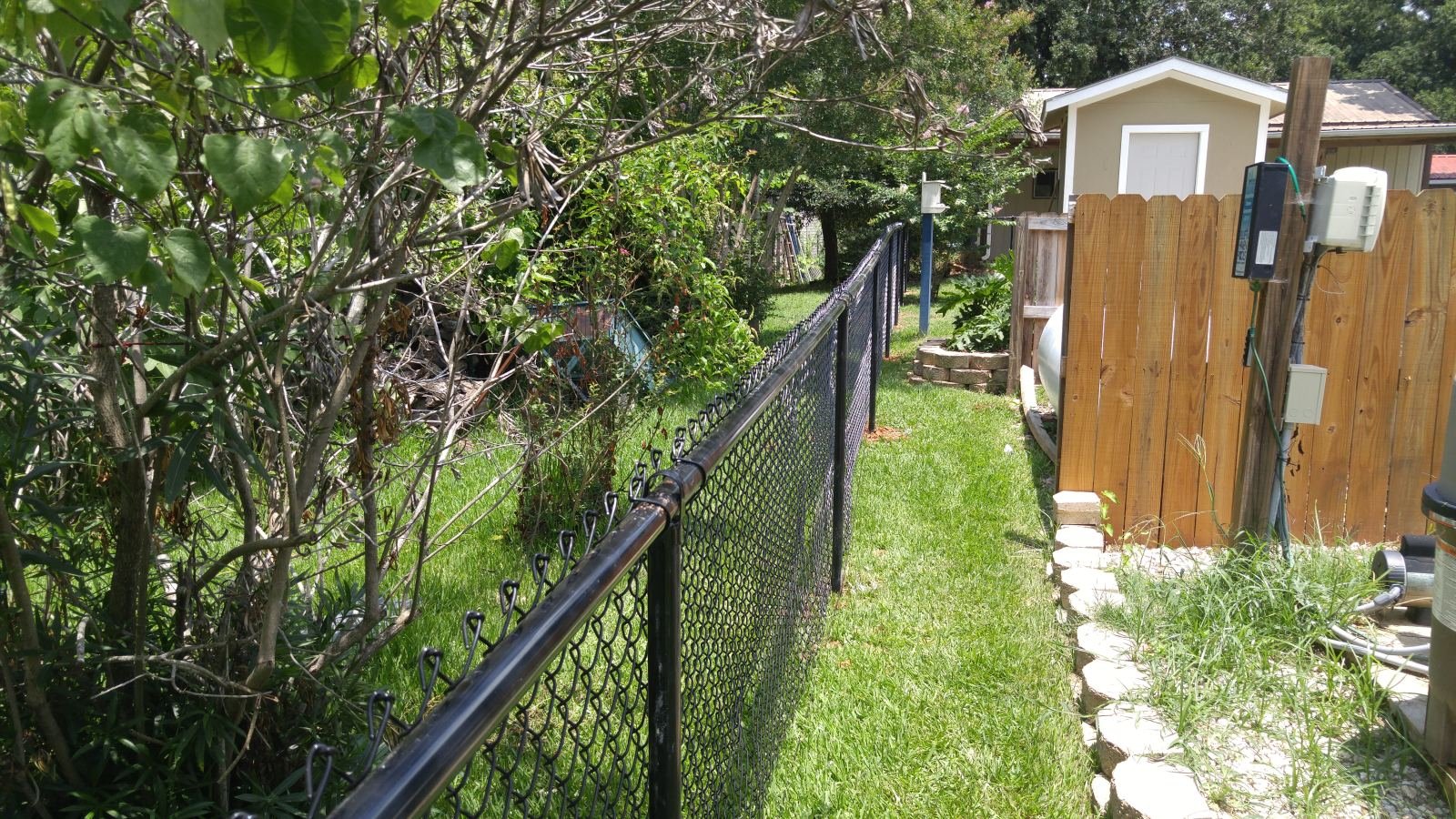 Automatic gate opener installed on a chain-link driveway gate