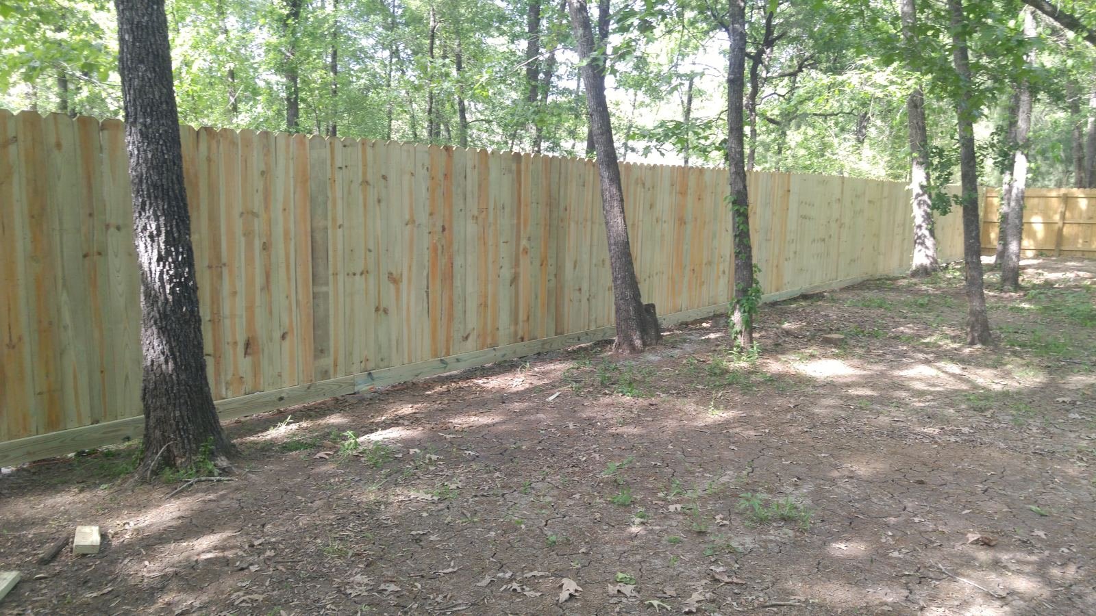 Wood privacy fence with a double drive gate