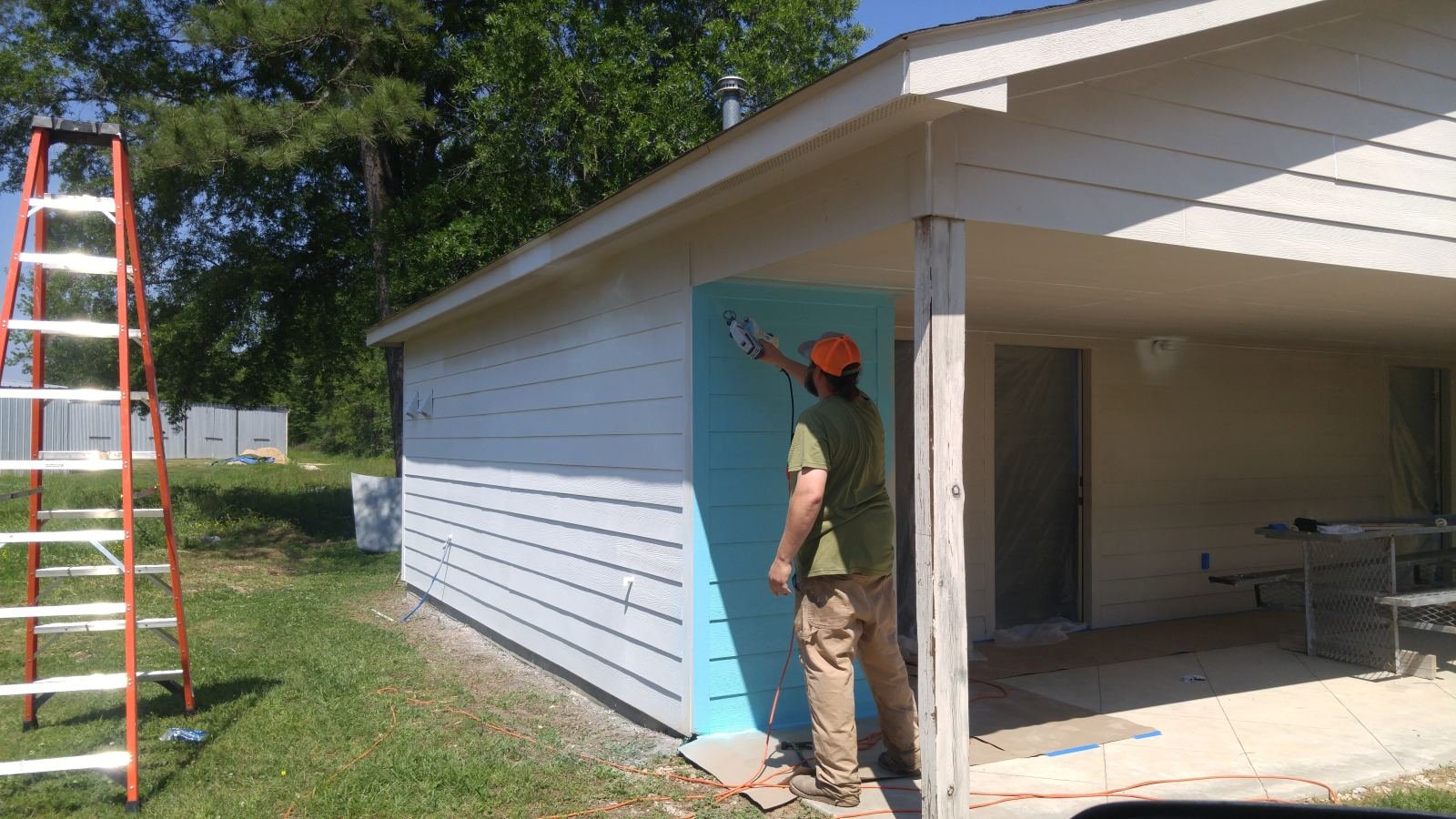 Crew staining an exterior structure