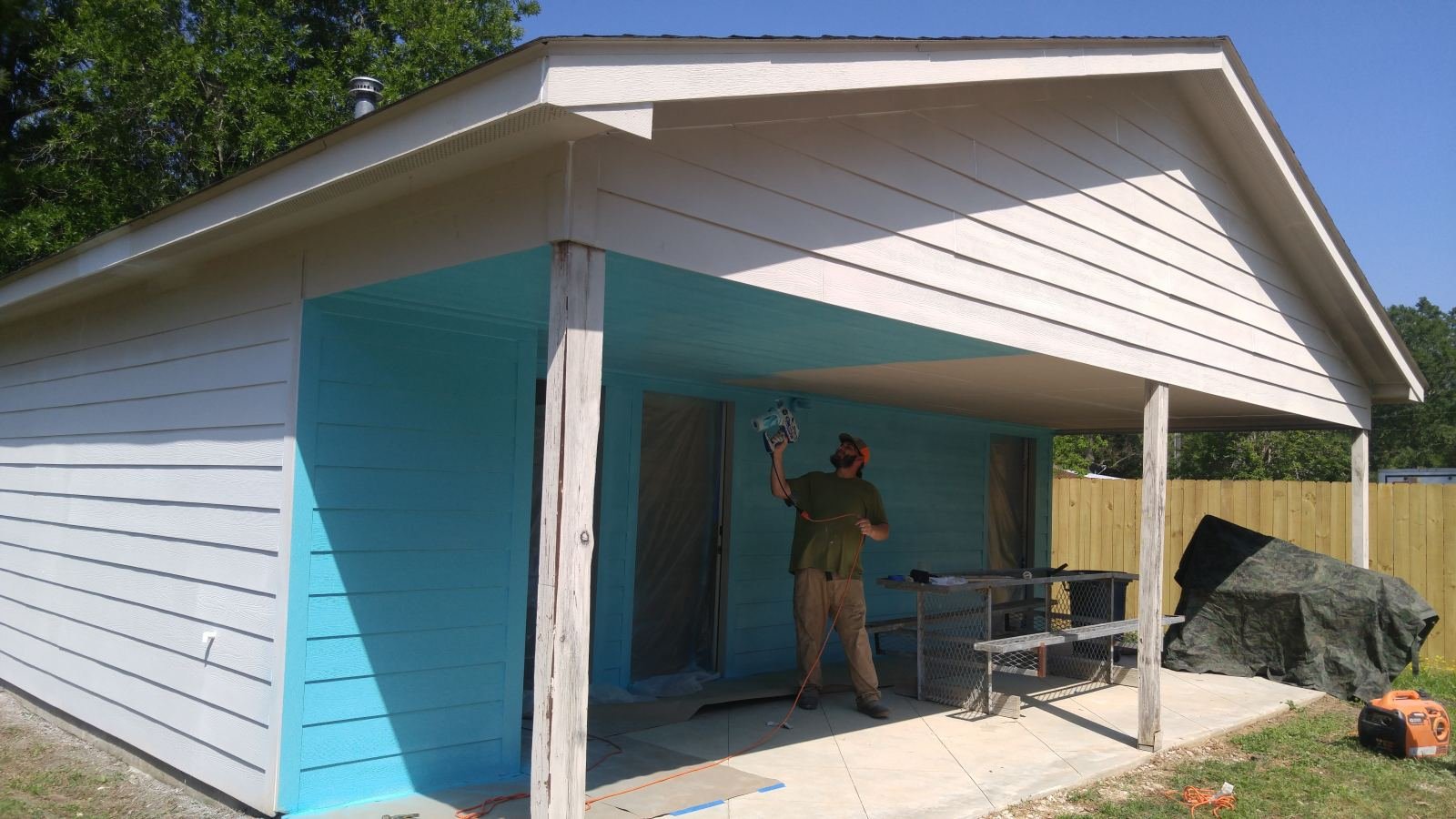 Crew applying stain to an exterior structure