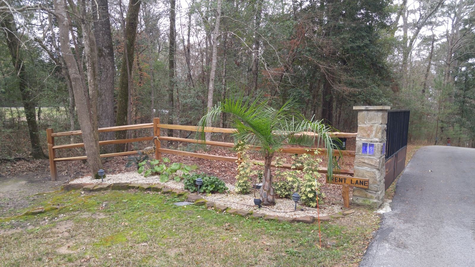 Cedar split-rail fence with stone entrance columns