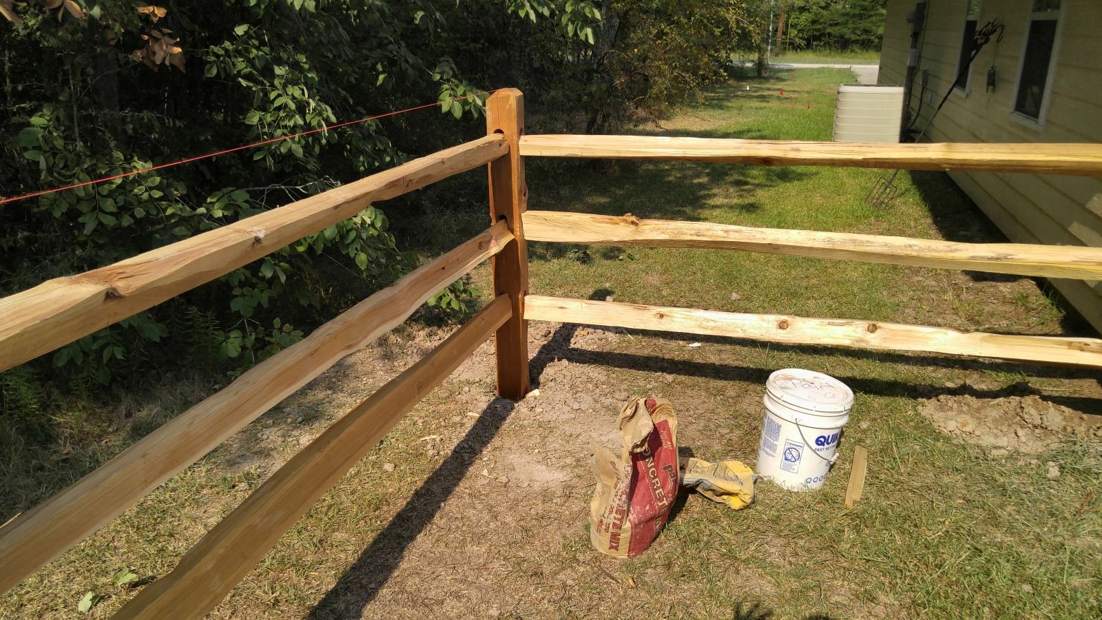 Freshly built cedar split-rail fence corner post