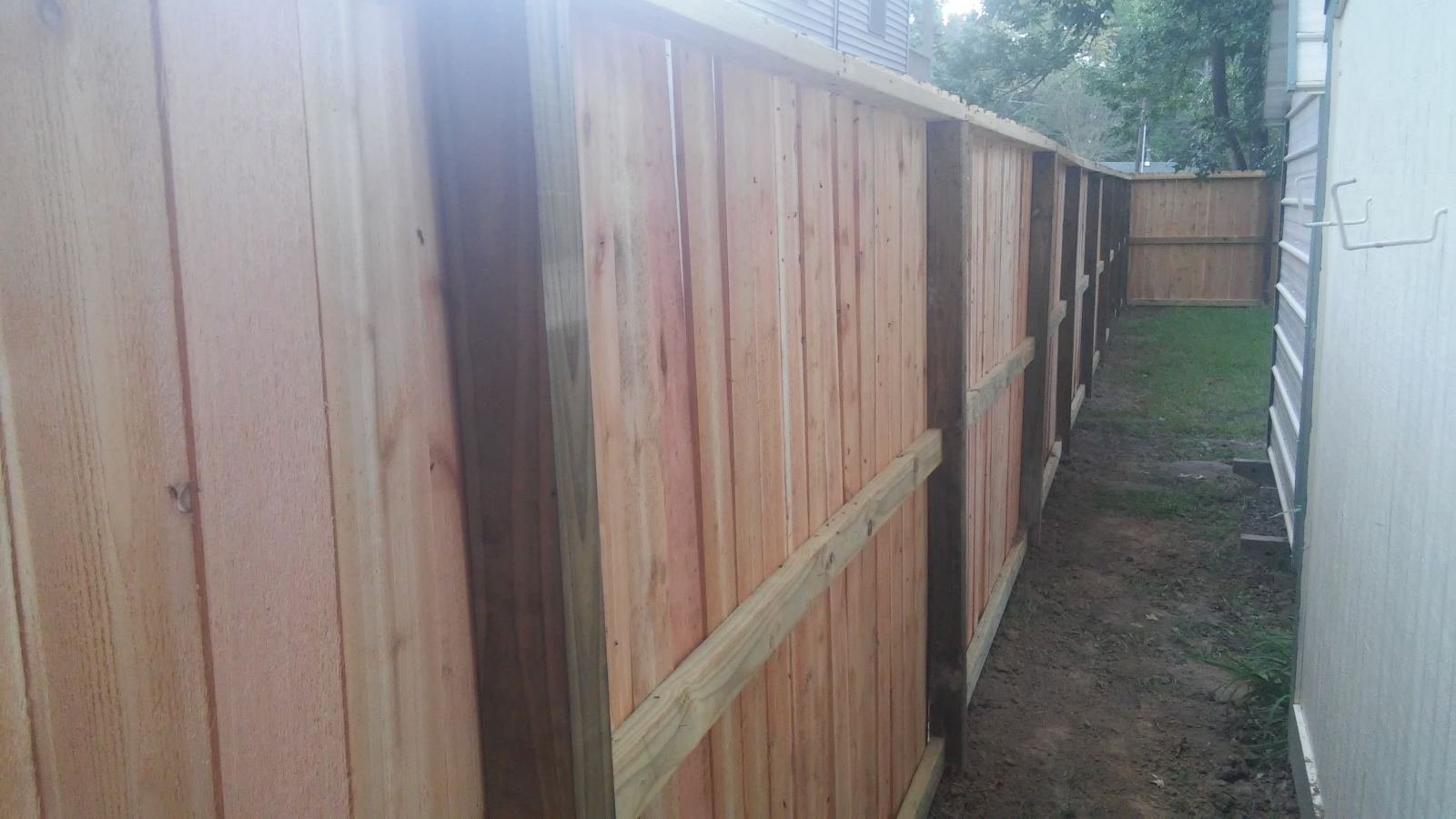 Wood privacy fence along a property line
