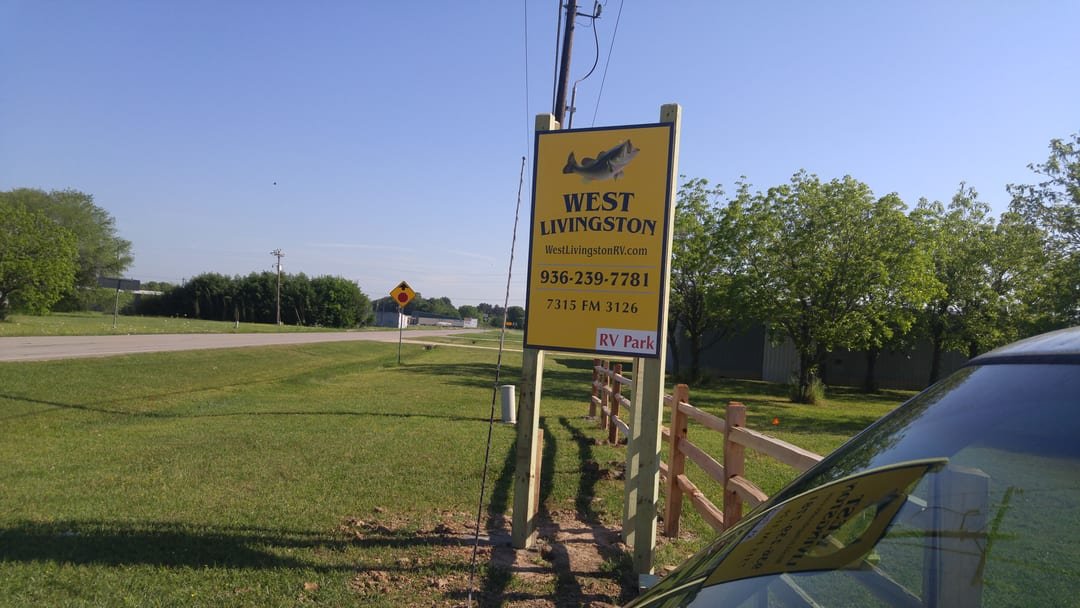 Cedar split rail fence beside a commercial sign