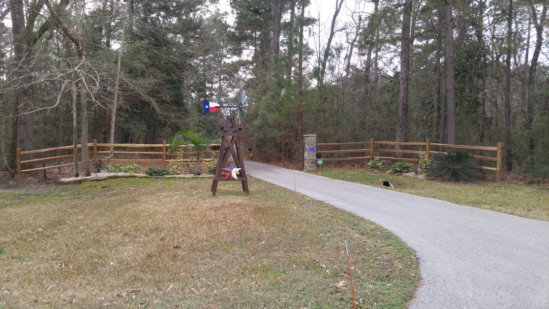 Cedar split rail fence along a driveway entrance
