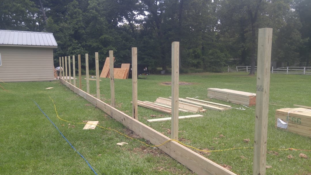 Pickets being hung on a three-rail frame