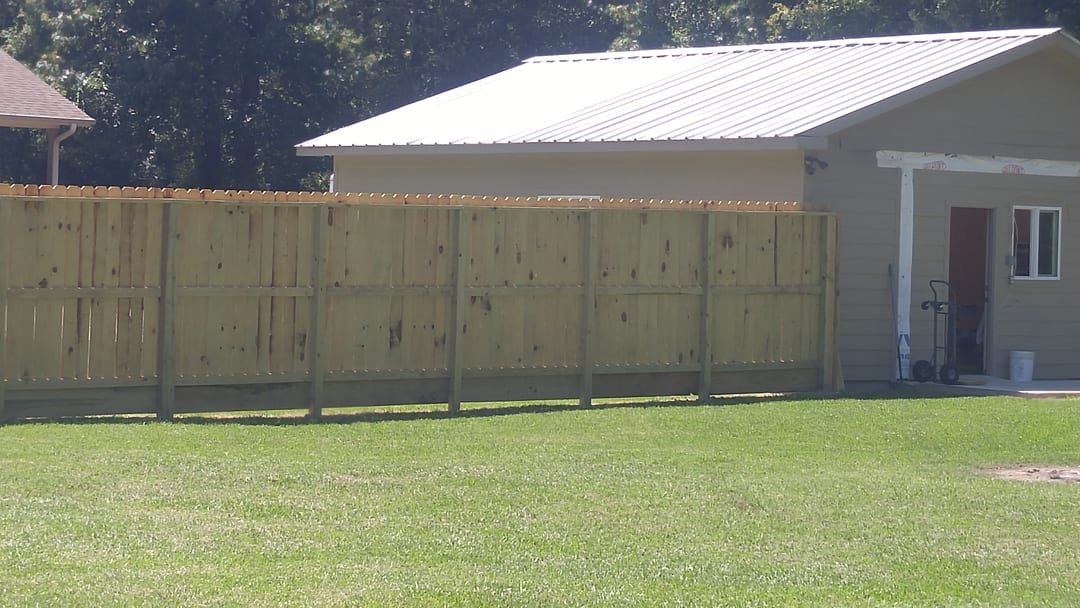 Wood privacy fence with a decorative top section