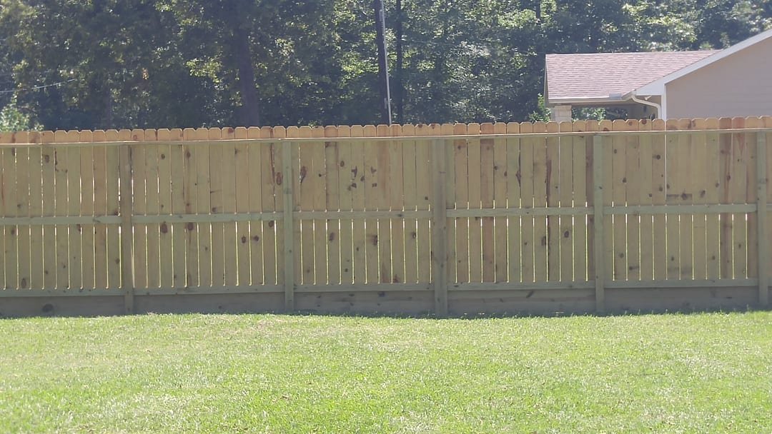 Wood privacy fence along a property line