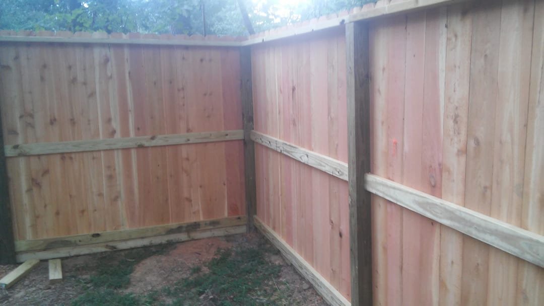 Spaced wood picket fence along a yard