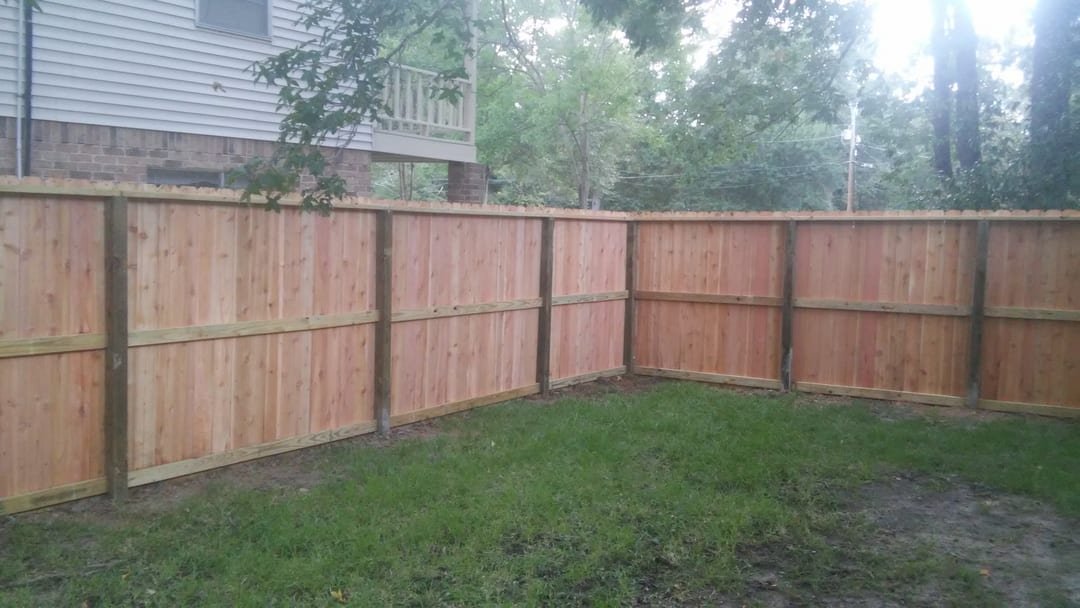 Wood privacy fence with dog-ear pickets