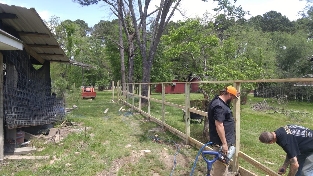 Weathered wood privacy fence before repair